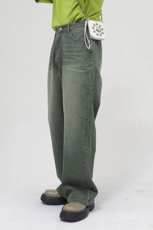 Faded olive relaxed wide leg denim jeans with a faded wash.