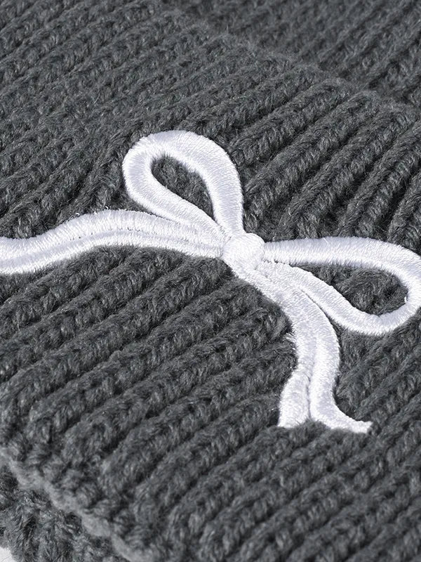 Gray ribbed knit beanie with embroidered white bow detail