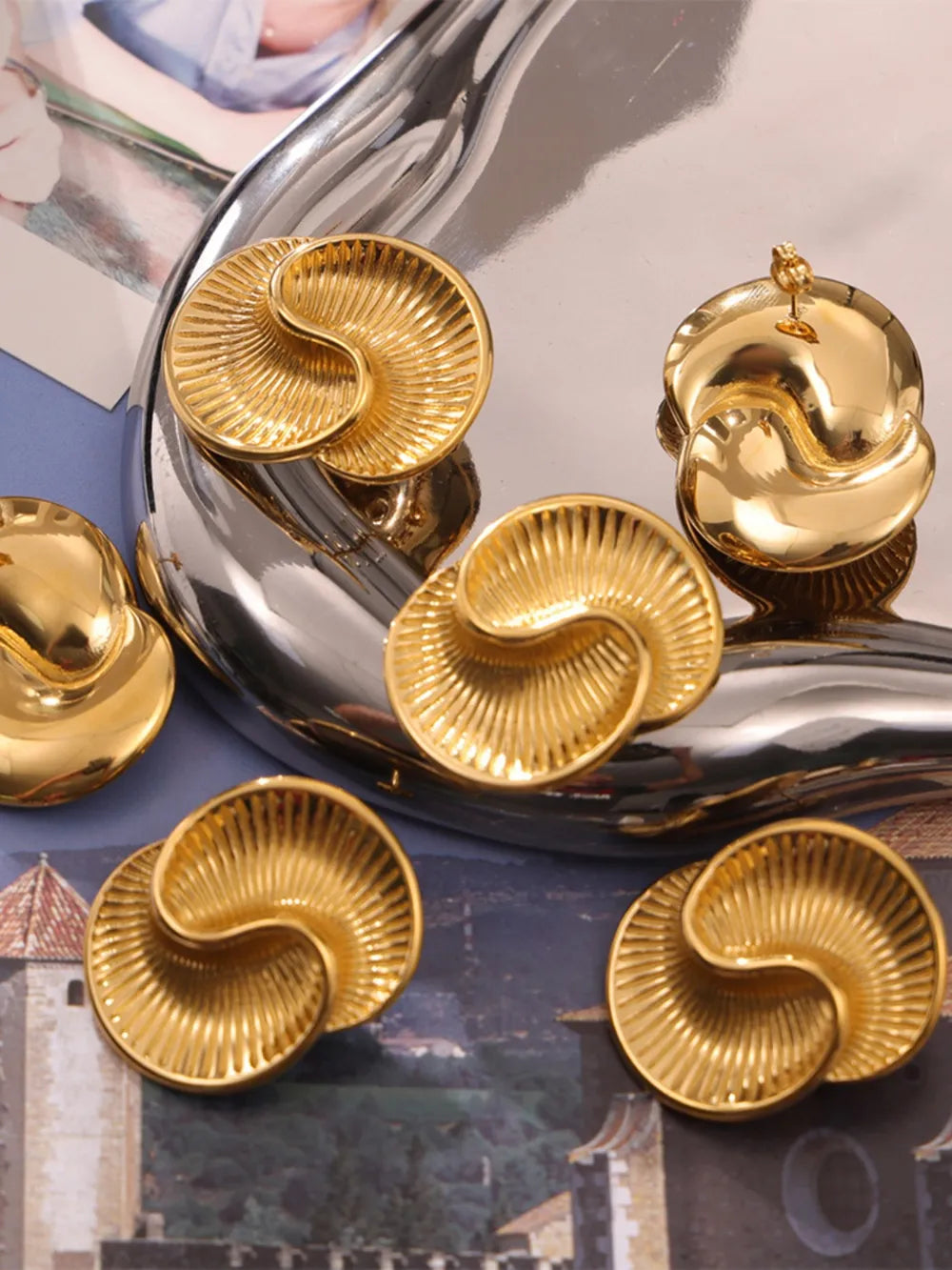 Gold vermeil shell stud earrings with sculptural, ribbed detail.