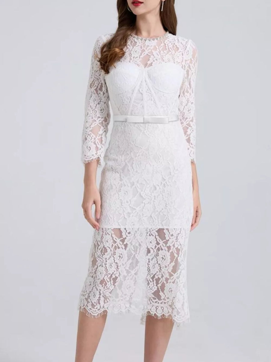 White lace midi dress with sheer sleeves, sweetheart neckline, and bow belt.