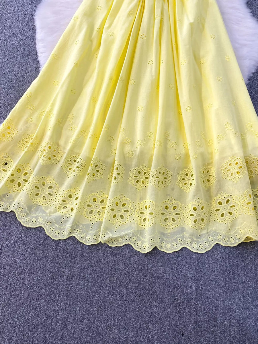 Yellow eyelet maxi dress with floral cutout hem detail