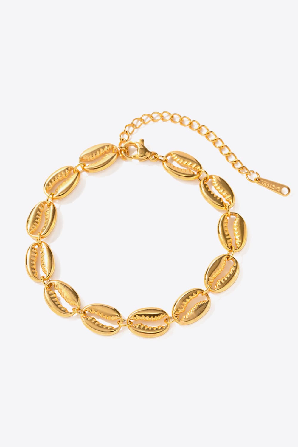 Gold cowrie shell bracelet with adjustable chain and lobster clasp.