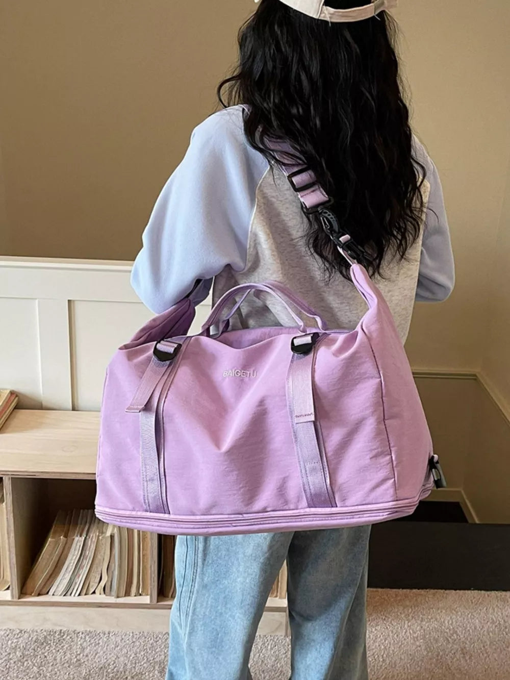 Spacious purple nylon travel bag with adjustable buckle straps and crinkled texture.