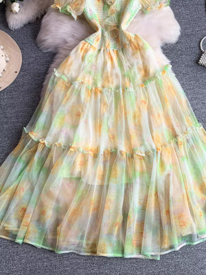 Floral tiered midi dress in sherbet with smocked bodice and sheer overlay.