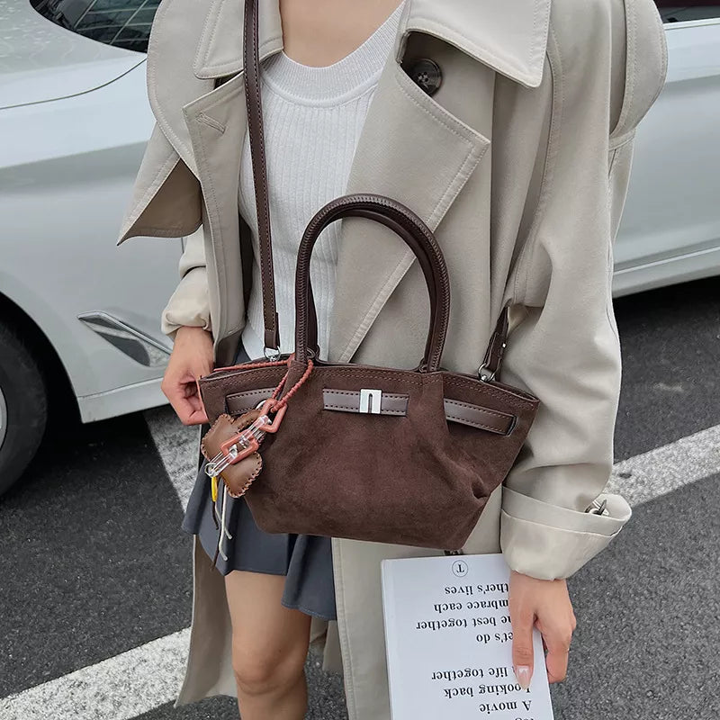 Elegant Suede And Leather Mini Tote in Coffee Brown with a lock detail and charm.