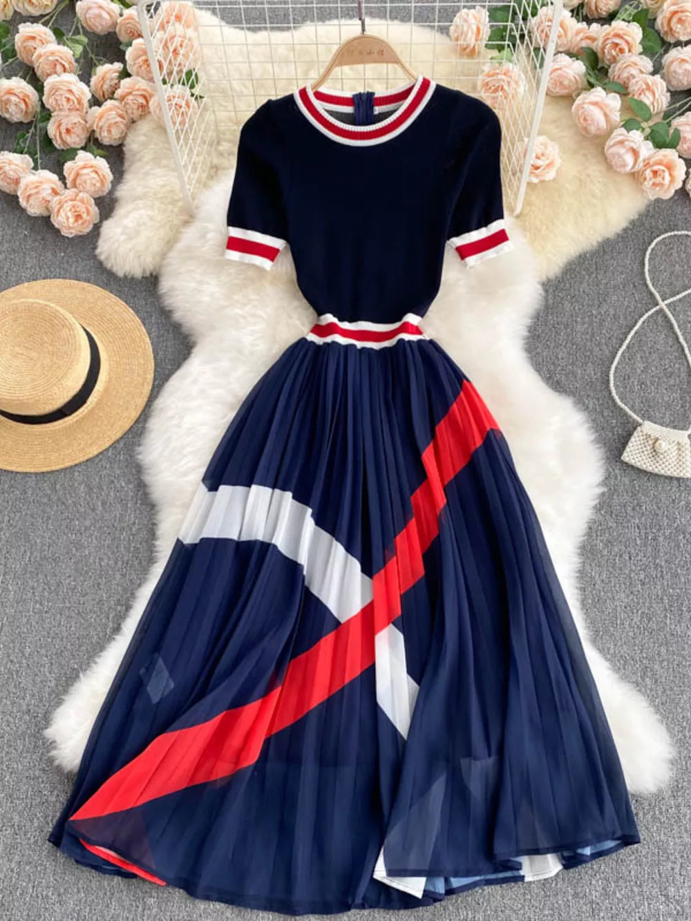 Navy midi dress with color block pleated skirt and striped trim