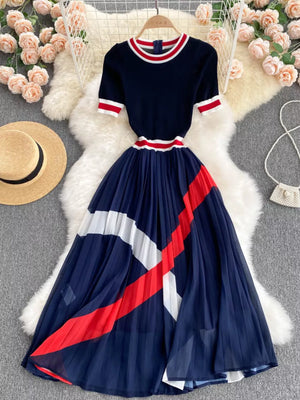 Navy midi dress with color block pleated skirt and striped trim