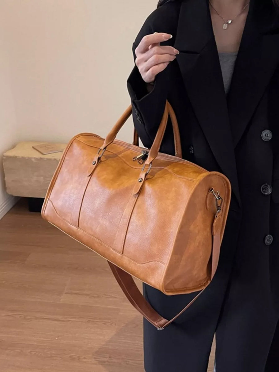 Cognac vintage leather duffle bag with top handles and shoulder strap