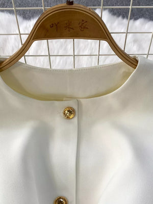 White belted two-piece set with gold button detail and pockets
