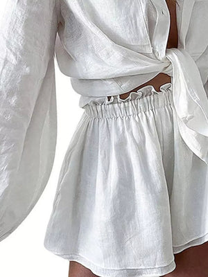 White linen-look two-piece set with tie-front shirt and ruffled elastic waist shorts