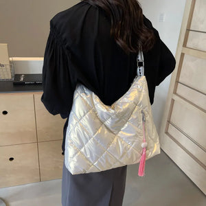 Diamond quilt padded shoulder bag in iridescent white with pink tassel detail.