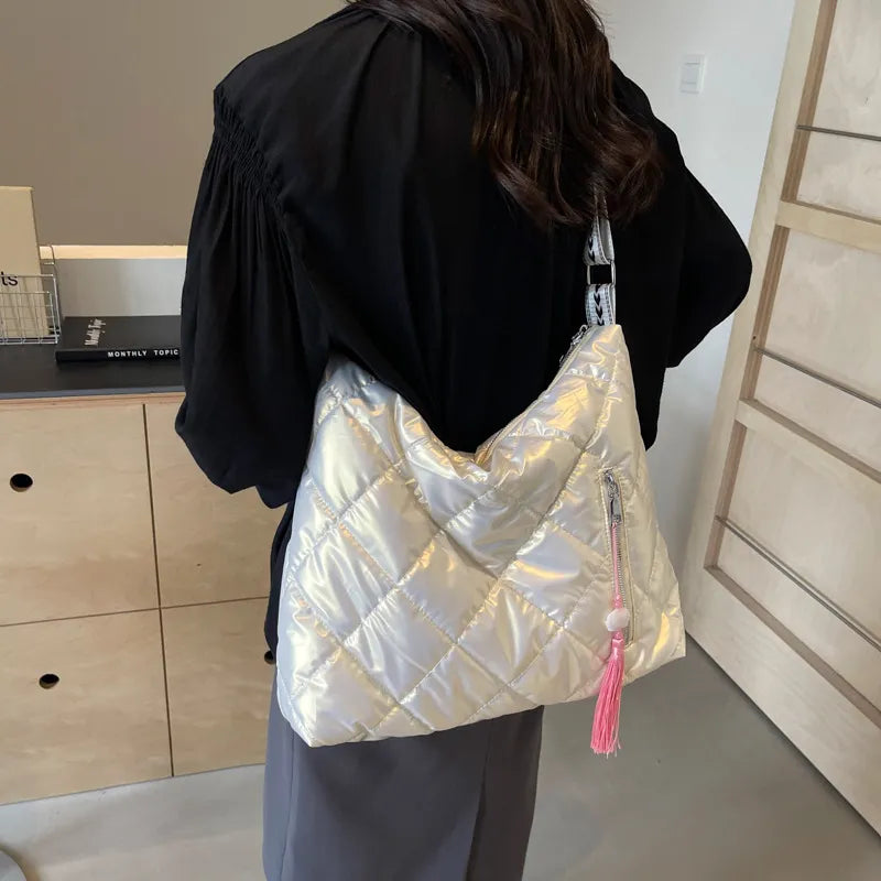 Diamond quilt padded shoulder bag in iridescent white with pink tassel detail.