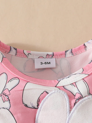 Pink baby dress with bunny applique and bow detail, size 3-6M tag visible.