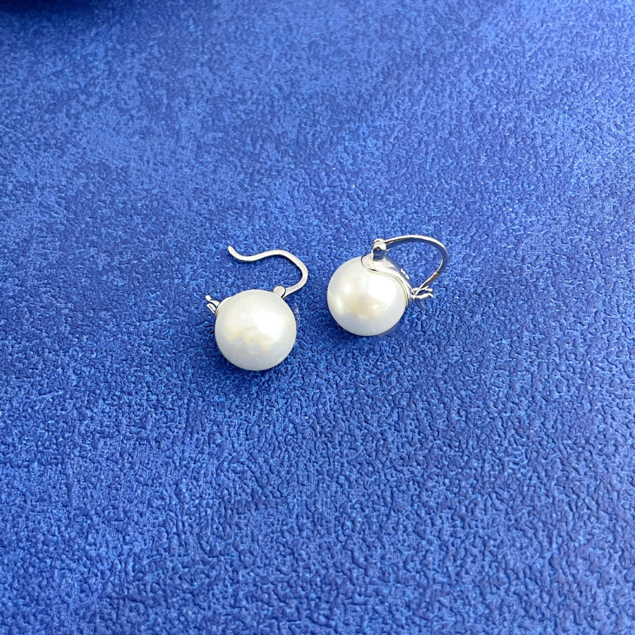 Plated pearl hoop earrings with silver findings and white pearls.