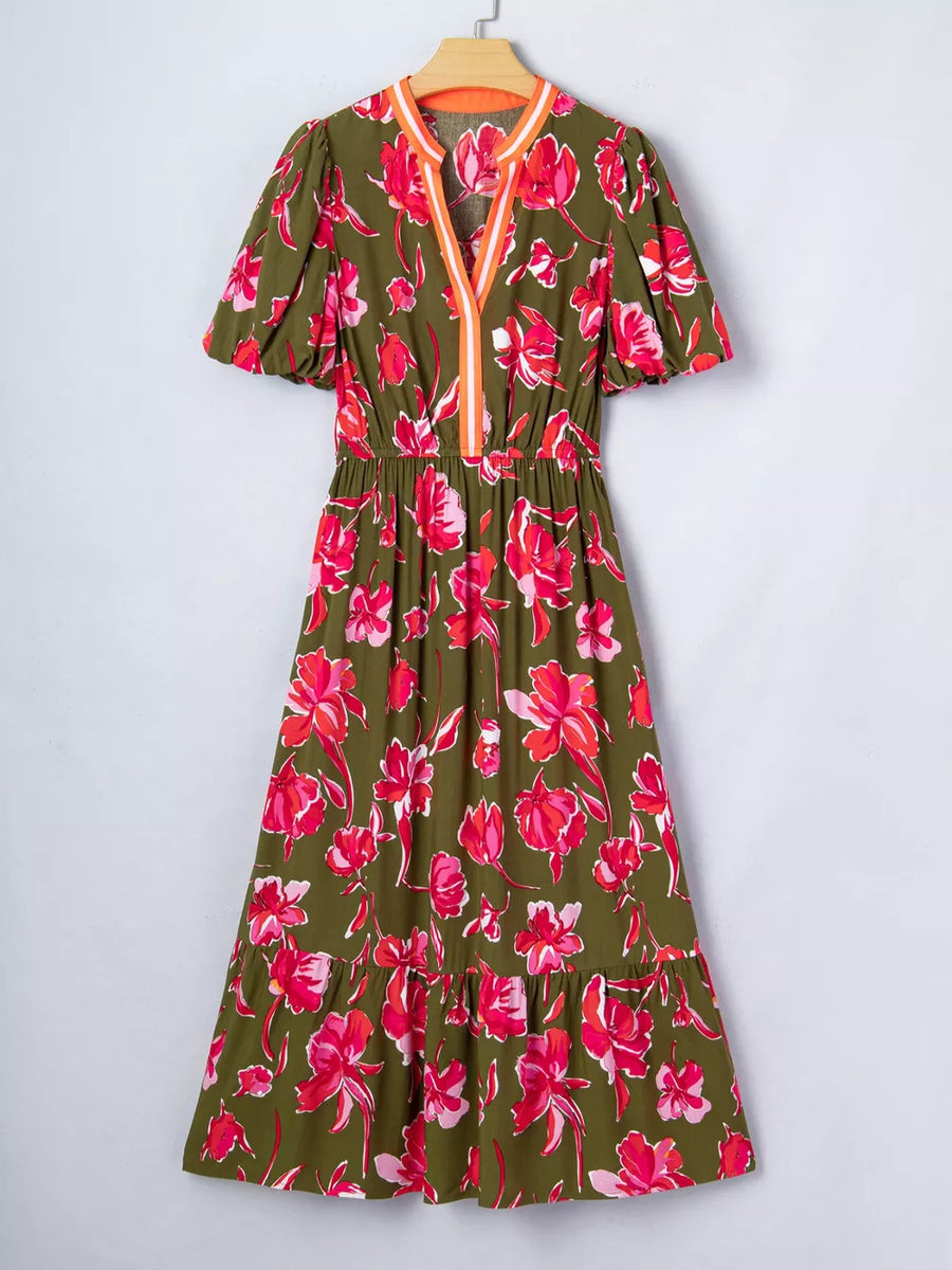 Print split neck dress with short puff sleeves, elastic waist, and tiered hem.