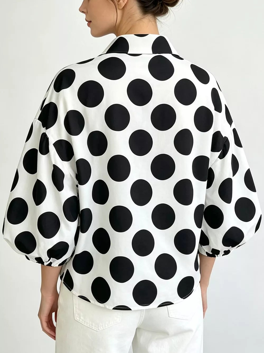black blouse featuring collared and polka dot