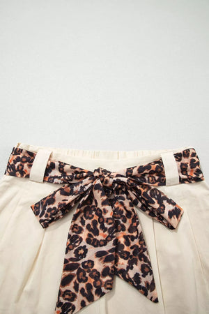 Cream pleated skirt with leopard print tie-waist belt and bow detail
