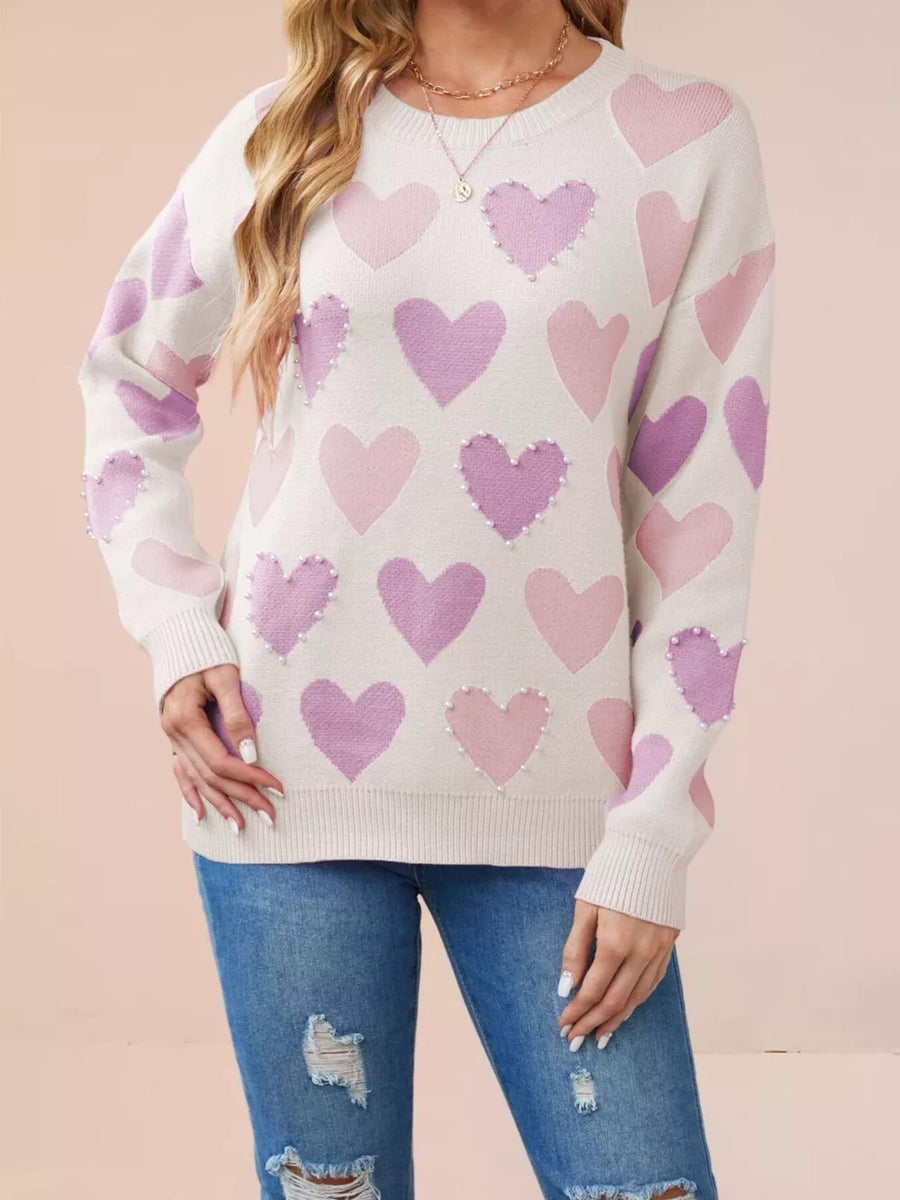 light pink pullover sweater featuring ribbed and heart