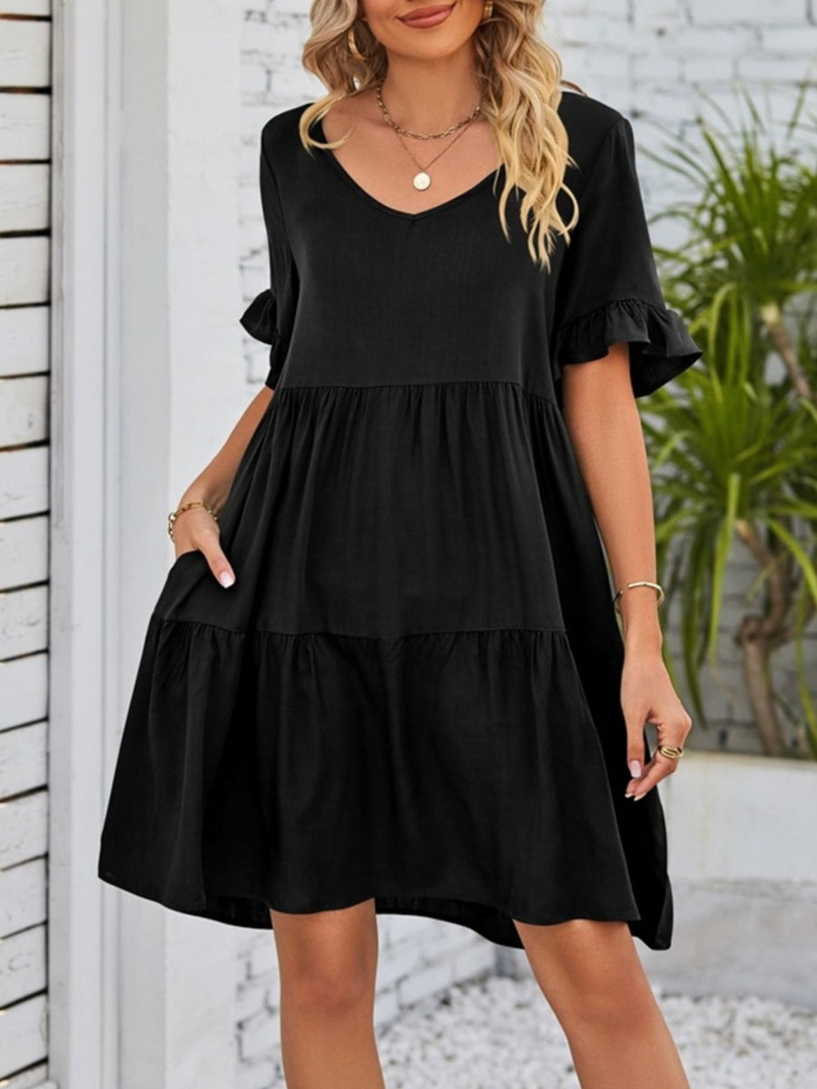 Black ruffled sleeve mini dress with tiered skirt and pockets.