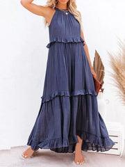 Navy blue ruffled maxi dress with halter neck and tiered skirt.