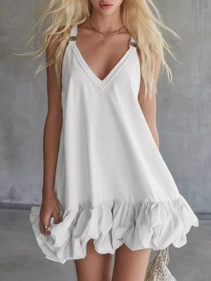 White V-neck mini dress with bubble hem and metal strap details.