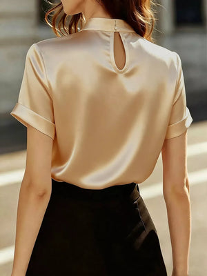 Tan satin mock-neck shirt with cuffed sleeves and back cutout detail