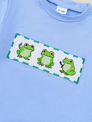 Light blue cotton baby set with playful frog embroidery detail.
