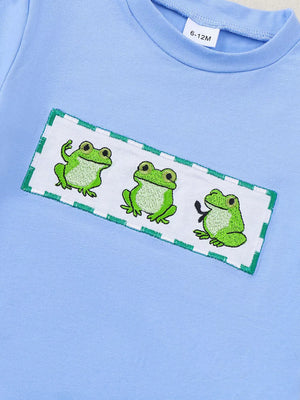 Light blue cotton baby set with playful frog embroidery detail.