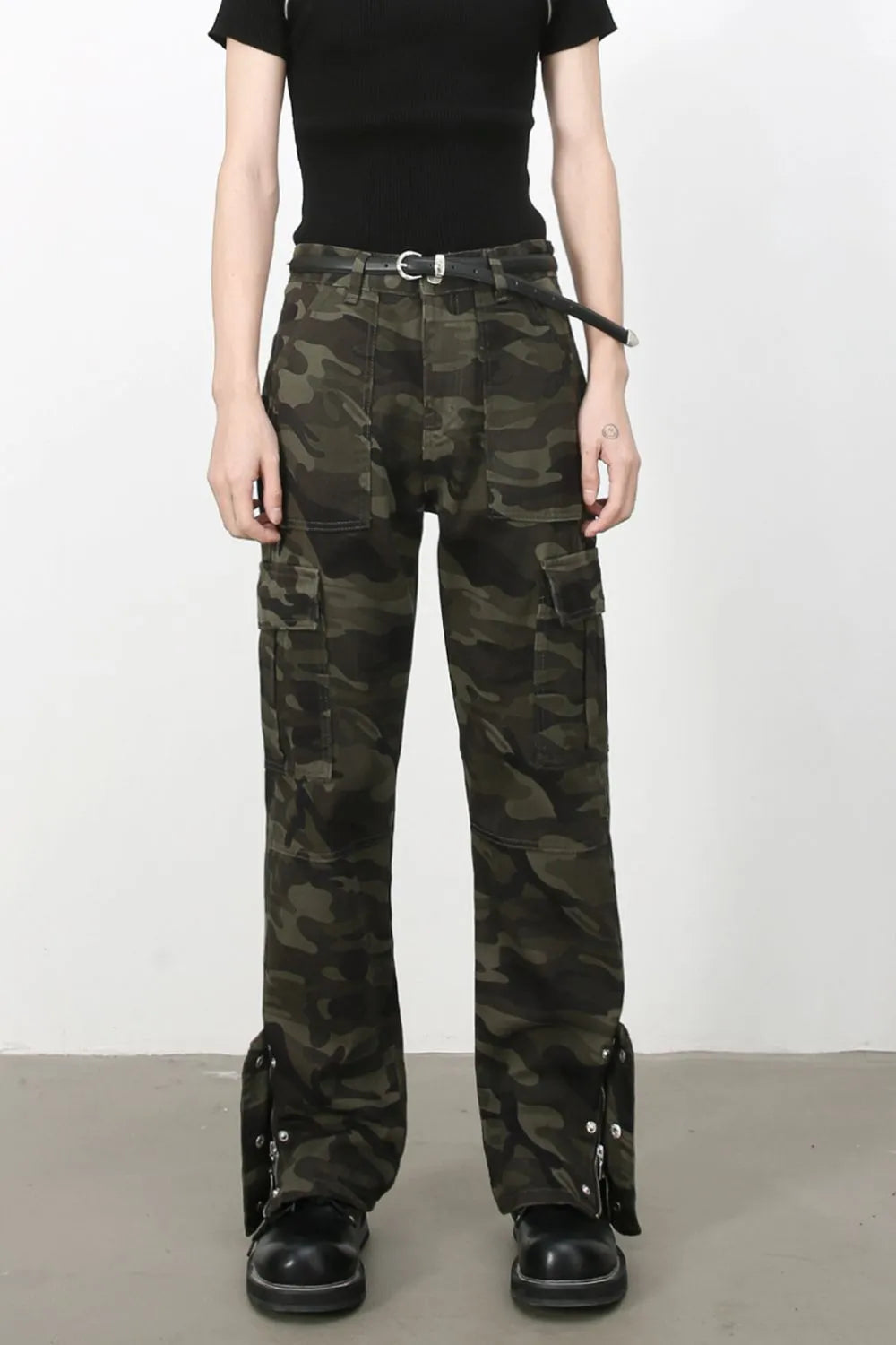 Camouflage utility flare cargo pants with multiple pockets and adjustable ankle straps.