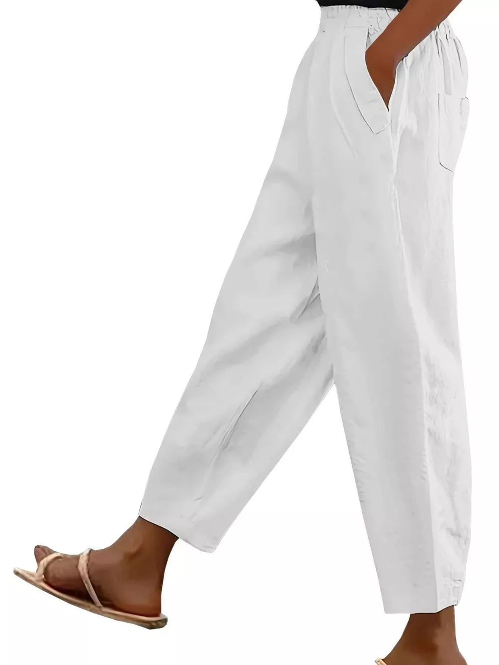 White wide-leg maternity pants with pockets and a relaxed fit.