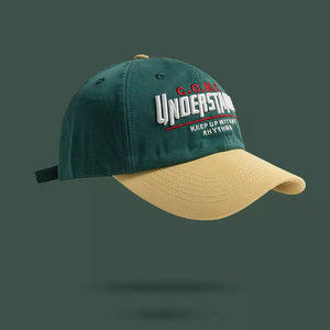 Embroidered baseball cap in green and tan with "UNDERSTAND" text and "KEEP UP WITH RHYTHMS" detail.