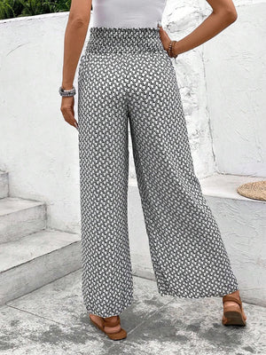 Palazzo pants in black and white geometric print with smocked waist, wide leg.