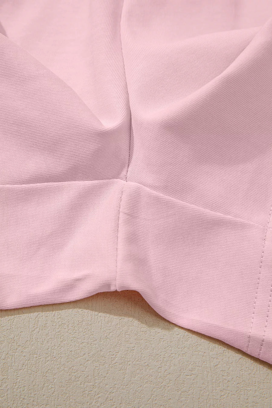 Blush pink pajama shorts set detail showing fabric texture and seams.