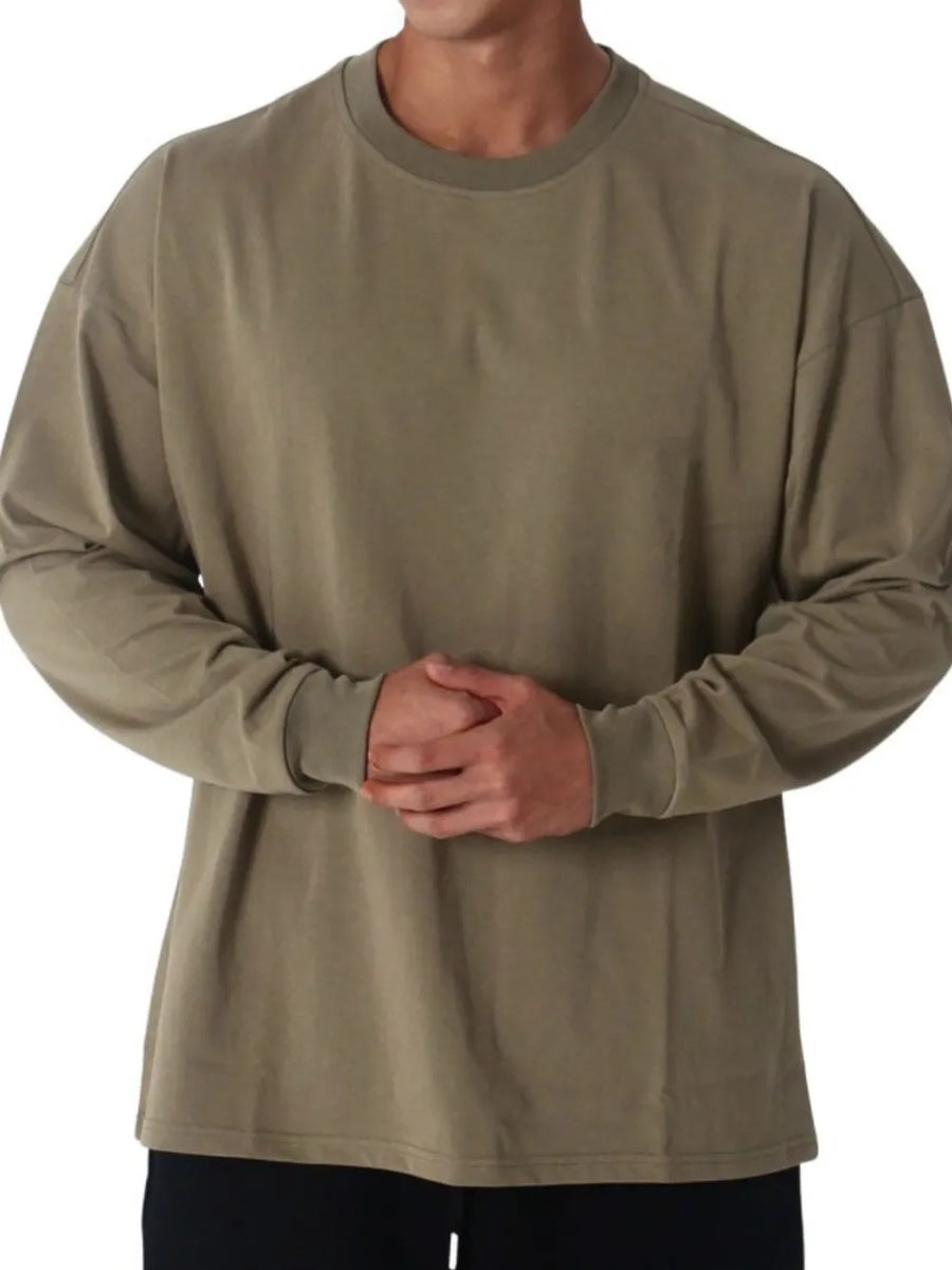Oversized crewneck long sleeve tee in olive washed cotton with relaxed fit.