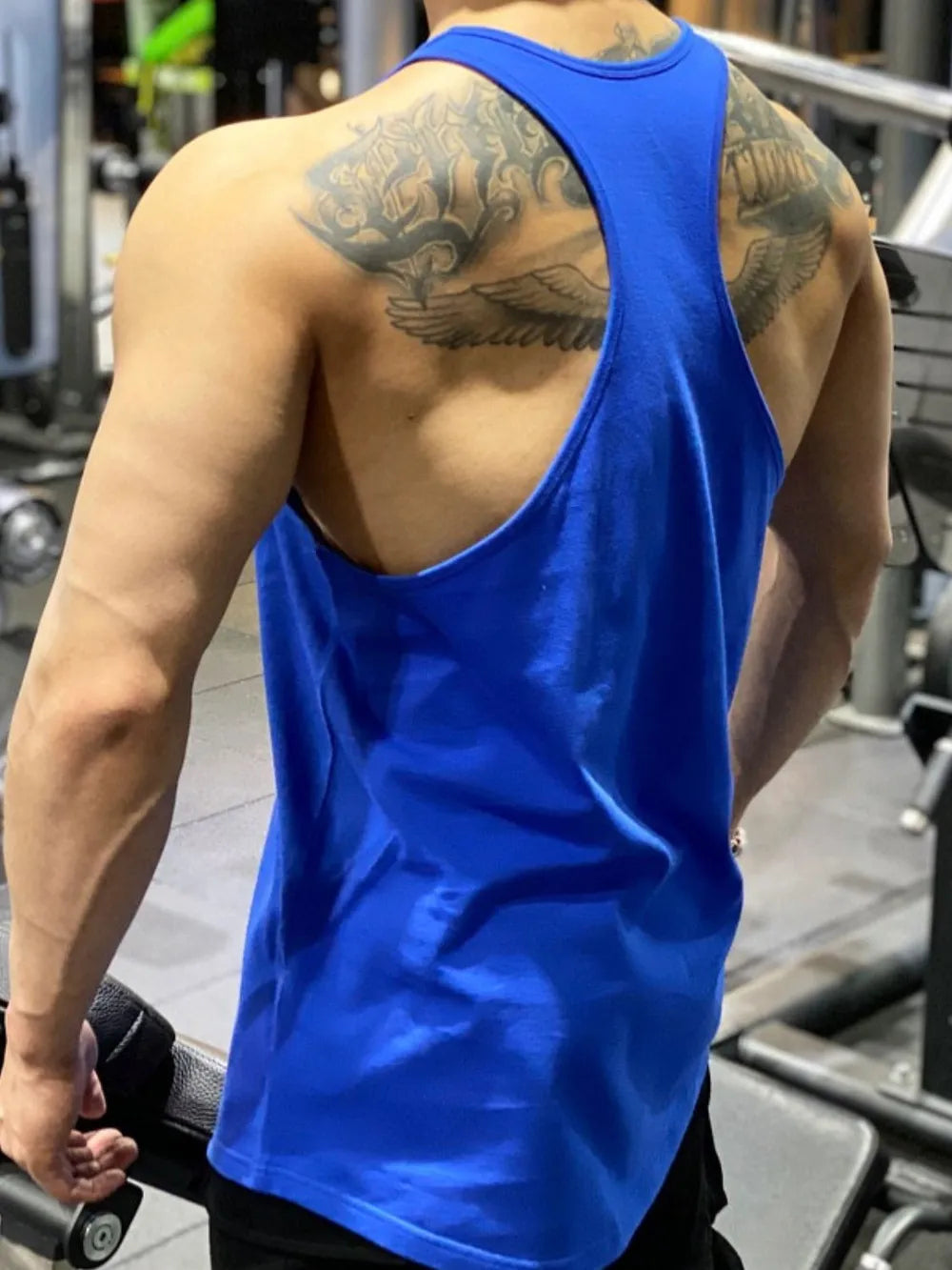 Royal blue performance racerback tank top with graphic detail on back