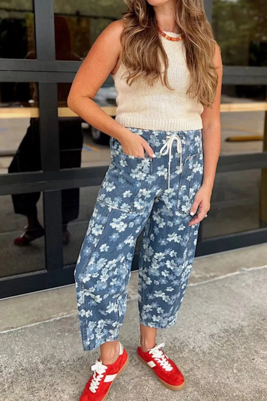 Blue floral barrel jeans with drawstring and pockets, cropped length.