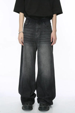 Oversized dark wash denim palazzo trousers with a wide leg and ombre effect.