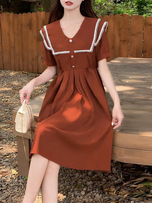Brown short sleeve dress with lace-trimmed sailor collar and decorative buttons.