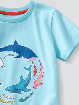 Light blue t-shirt with a graphic print of various colorful sharks and fish.