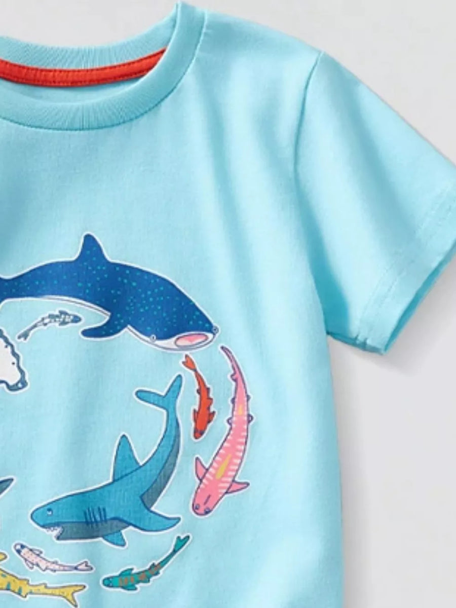 Light blue t-shirt with a graphic print of various colorful sharks and fish.