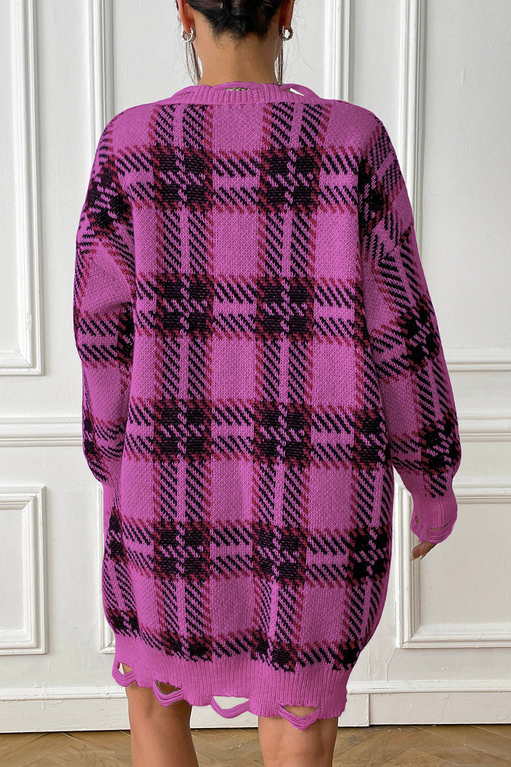 Fuchsia plaid knit mini dress with distressed hem and long sleeves.