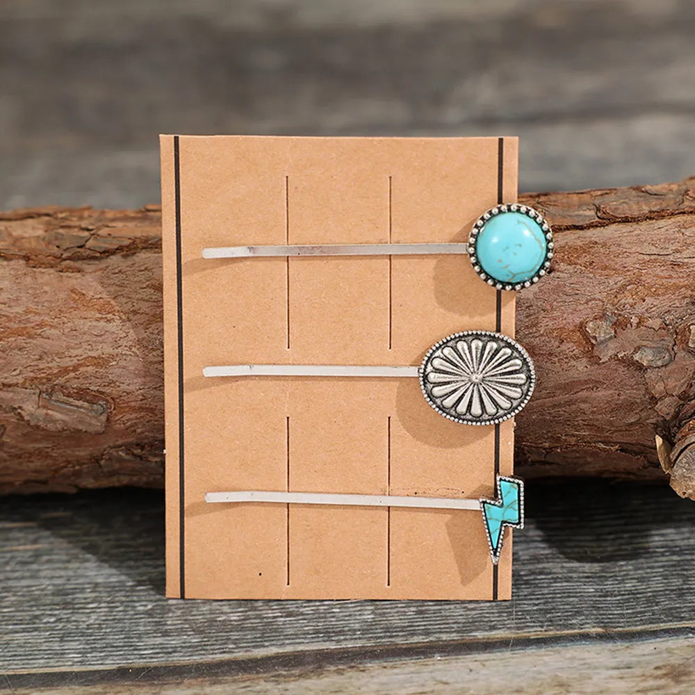 Southwestern hair pins with turquoise stone, sunburst, and lightning bolt charms.