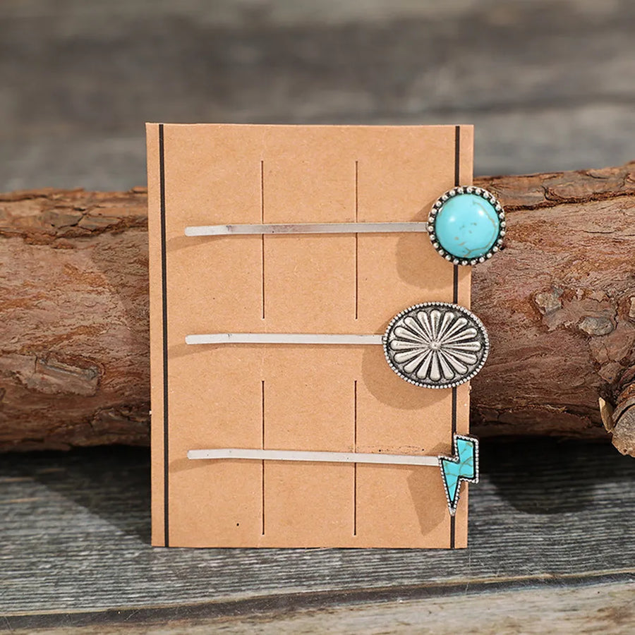 Southwestern hair pins with turquoise stone, sunburst, and lightning bolt charms.