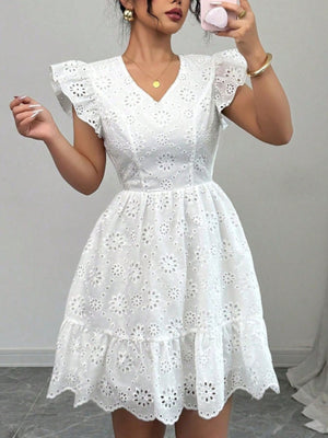 White eyelet mini dress with ruffle sleeves and tiered hem
