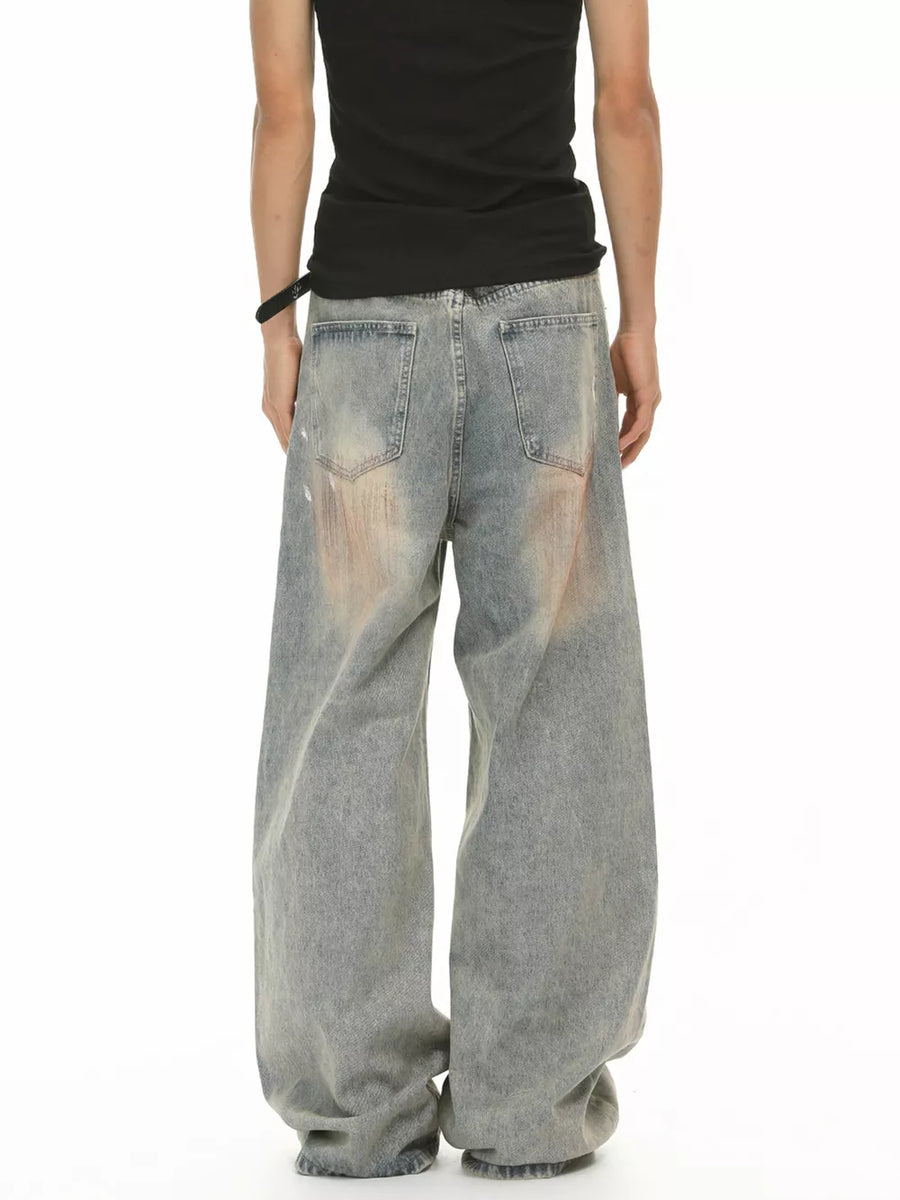 Relaxed fit vintage wash jeans in blue denim with distressed details and a baggy cut.