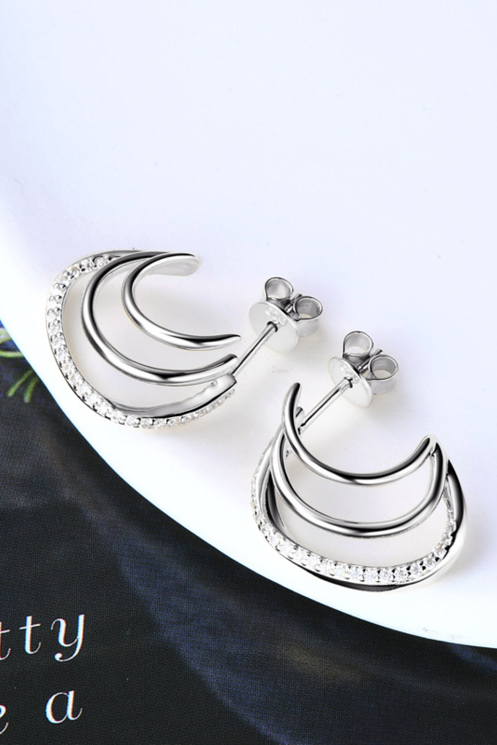 Silver triple hoop diamond stud earrings with pavé diamond accents