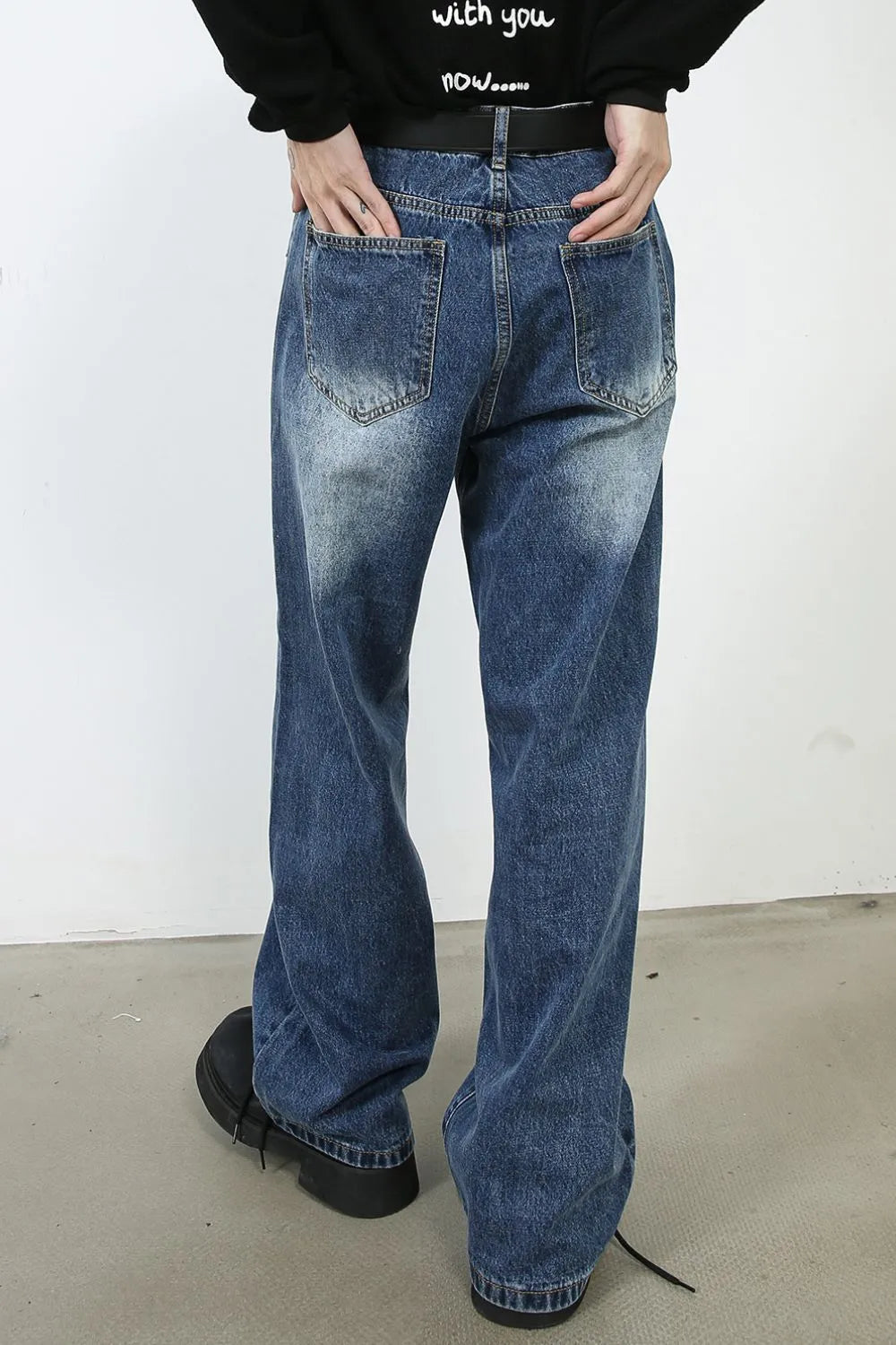 Panel seam wide leg denim jeans in medium wash with distressed details.