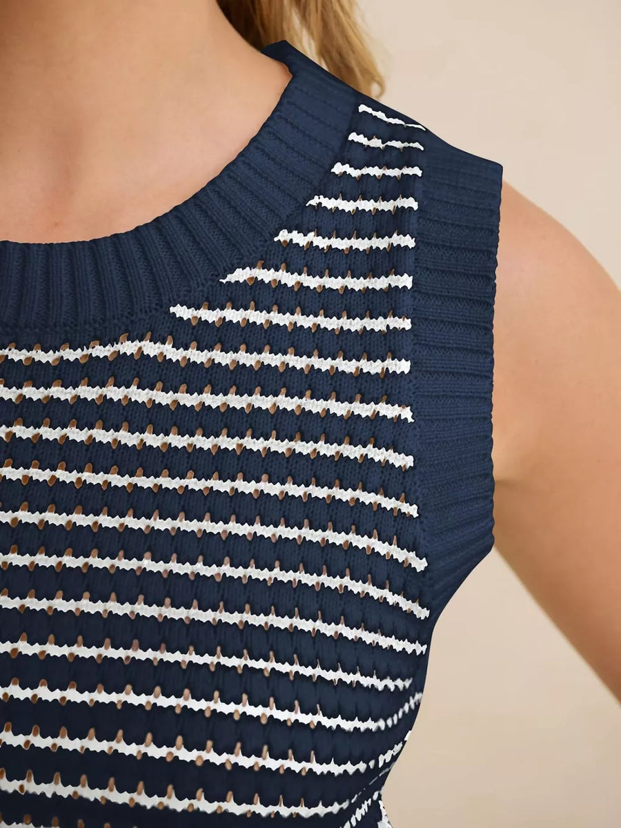 Navy blue knit sweater vest with white and brown horizontal stripes and textured details.