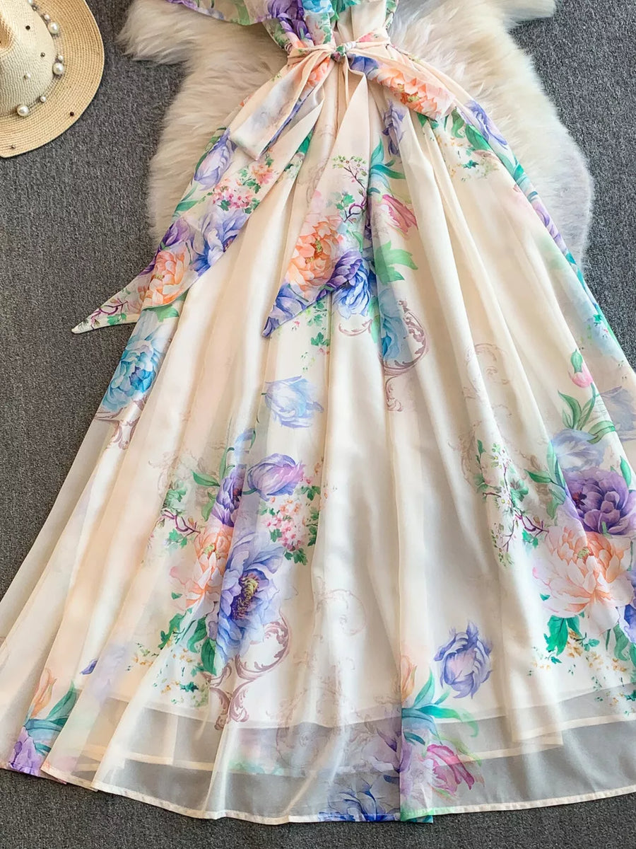 Botanical off-shoulder A-line dress in cream with floral print and belted waist.