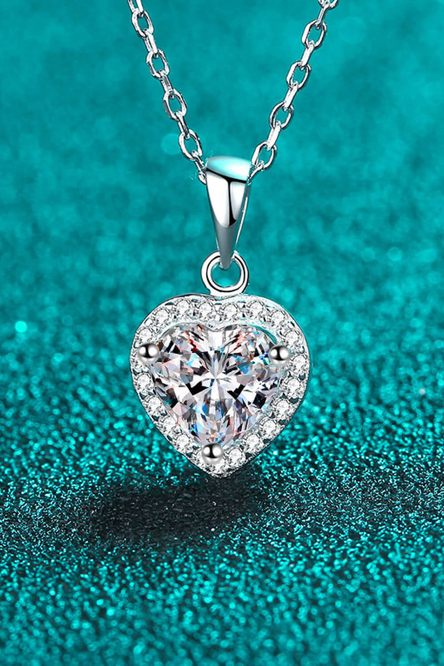 Silver heart cut halo pendant necklace with clear crystal on a sterling silver chain.